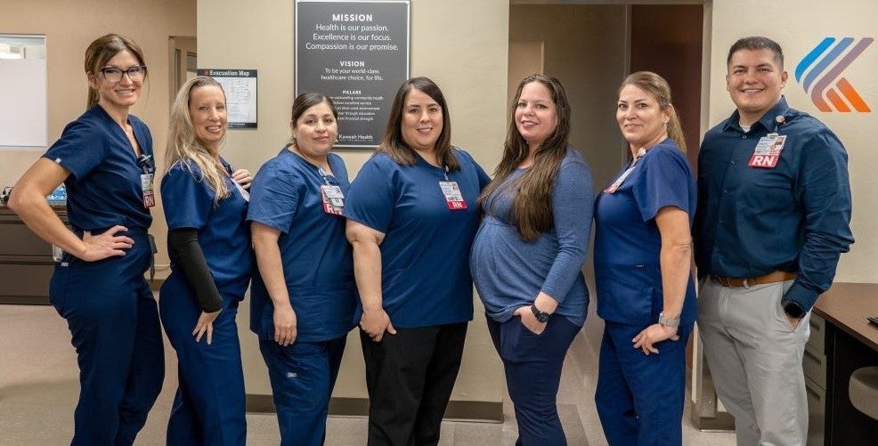 Kaweah Health infusion center team standing in a line smiling