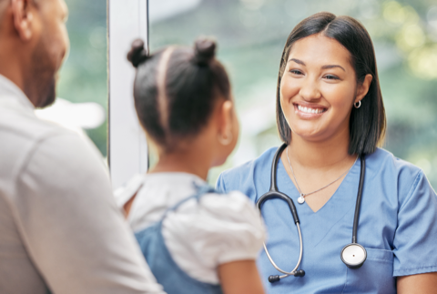 Doctor smiling with young patient