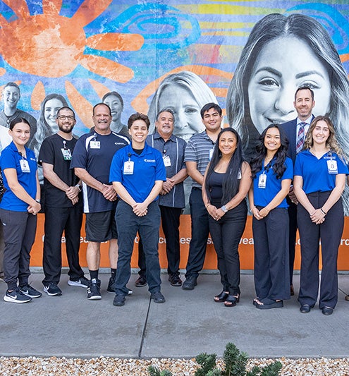 Employees with the children who are volunteering.